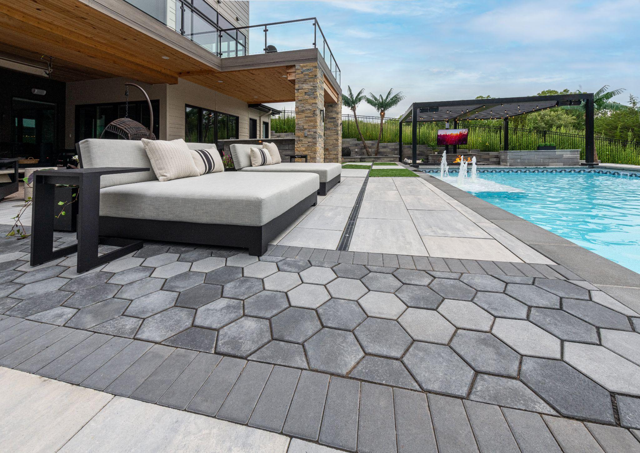 Contemporary backyard patio with geometric pavers and pool