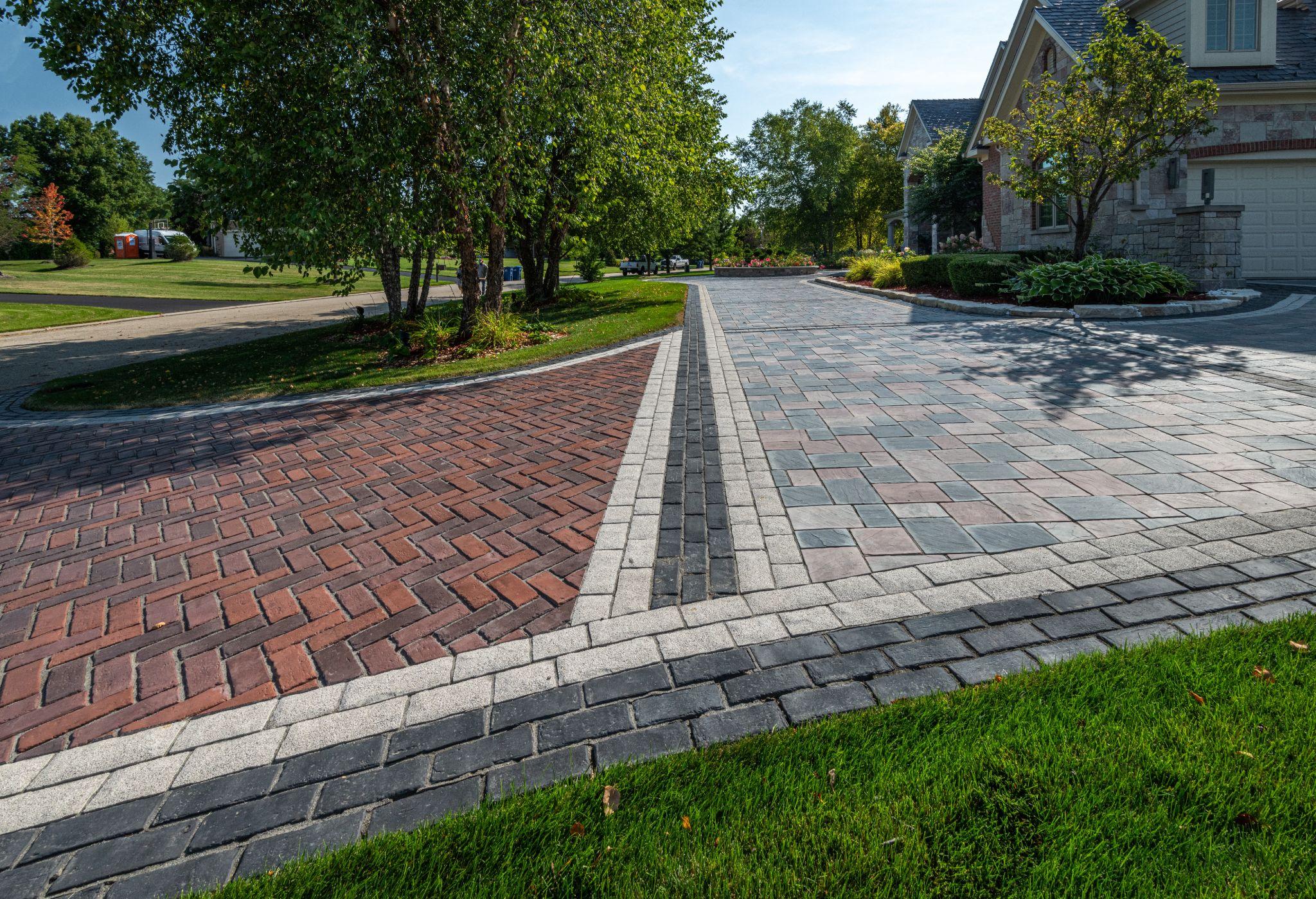 Decorative driveway with contrasting brick and stone borders