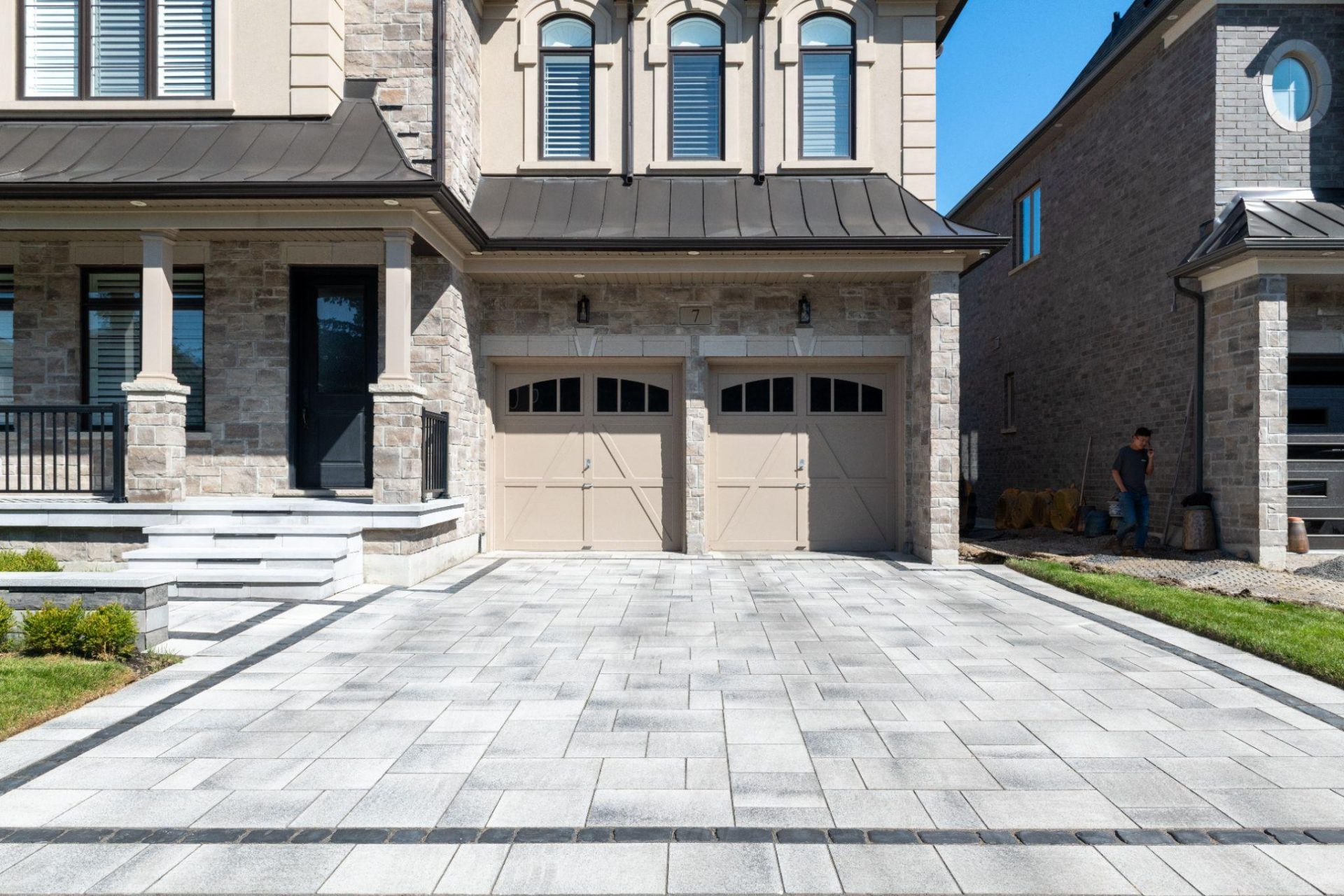 Interlocking paver driveway in front of stone home