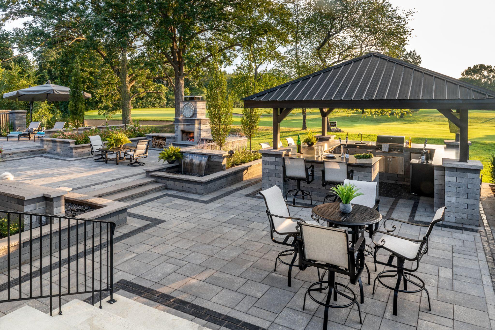 Outdoor kitchen patio with large format stone pavers